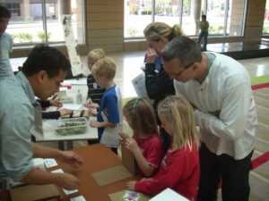 kids at an outreach event make their own plant presses